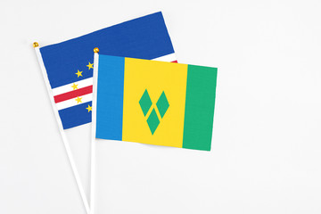 Saint Vincent And The Grenadines and Cape Verde stick flags on white background. High quality fabric, miniature national flag. Peaceful global concept.White floor for copy space.