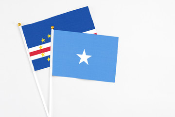 Somalia and Cape Verde stick flags on white background. High quality fabric, miniature national flag. Peaceful global concept.White floor for copy space.