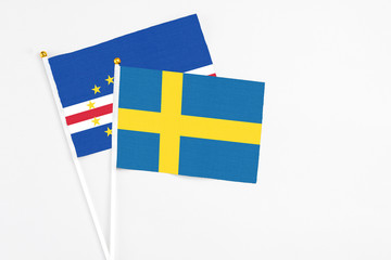 Sweden and Cape Verde stick flags on white background. High quality fabric, miniature national flag. Peaceful global concept.White floor for copy space.