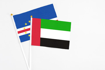 United Arab Emirates and Cape Verde stick flags on white background. High quality fabric, miniature national flag. Peaceful global concept.White floor for copy space.