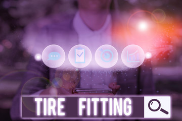 Text sign showing Tire Fitting. Business photo text The act of putting the tires onto the wheels of...