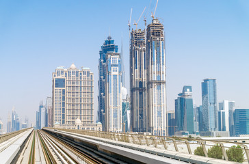 Fototapeta na wymiar Dubai Cityscape on Sunny Day with High-rise Skyscrapers