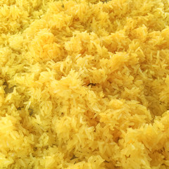 yellow rice yeast fermentation healthy thai food traditional appetizing cuisine,close up whole grain cooked yellow sticky rice seasoning with pumpkin, kumin herbs.top view pattern texture background.