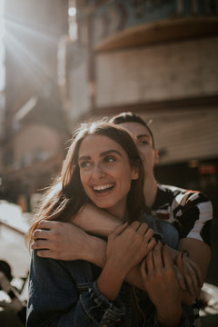 Young couple embracing each other on joyful urban exploration