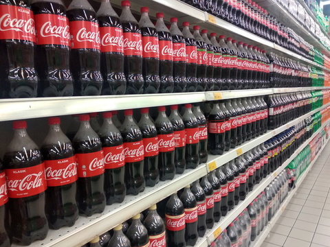 KUALA LUMPUR, MALAYSIA -JULY 16, 2018: COKE-COLA drinks in large bottles are displayed on a shelf for sale in a large supermarket. Placed in large quantities based on high demand.