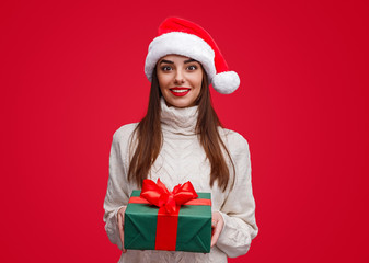 Young woman giving Christmas present