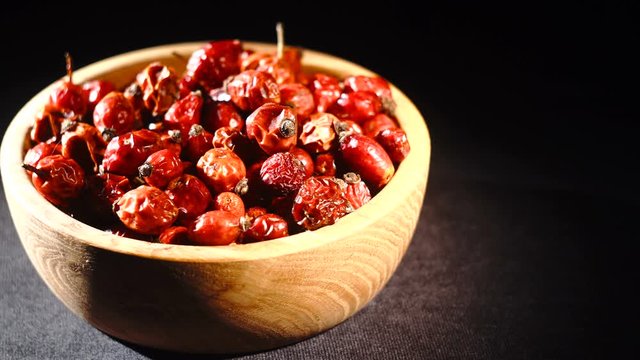 Detail macro view of dog rose hips in bowl latin name Fructus cynosbati . Dried rose hips are important source of vitamins in alternative medicine.