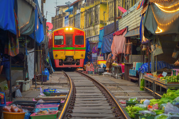 Rom Hoop market. Thai Railway with a local train run through Mae Klong Market in Samut Songkhram...