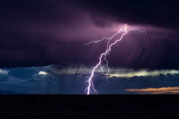 Fototapeta na wymiar Lightning and storm clouds at sunset