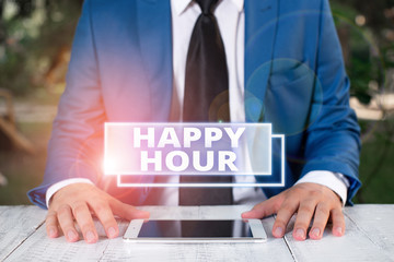 Writing note showing Happy Hour. Business concept for when drinks are sold at reduced prices in a bar or restaurant Businessman in blue suite with a tie holds lap top in hands