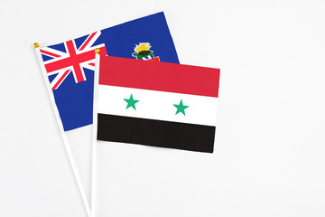 Syria and Cayman Islands stick flags on white background. High quality fabric, miniature national flag. Peaceful global concept.White floor for copy space.
