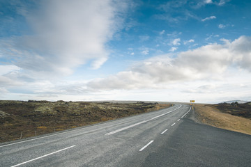Tarmac scenic road at Iceland. Beautiful landscape, cloudy blue sky. Backplate.