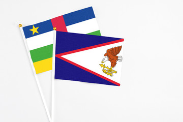 American Samoa and Central African Republic stick flags on white background. High quality fabric, miniature national flag. Peaceful global concept.White floor for copy space.