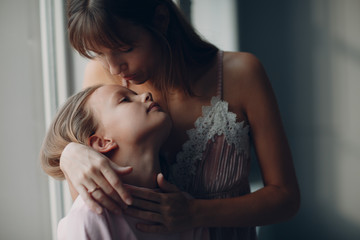 Mother hug with a little daughter. Family and mother's day concept.