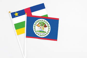 Belize and Central African Republic stick flags on white background. High quality fabric, miniature national flag. Peaceful global concept.White floor for copy space.