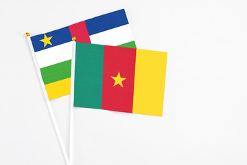 Cameroon and Central African Republic stick flags on white background. High quality fabric, miniature national flag. Peaceful global concept.White floor for copy space.