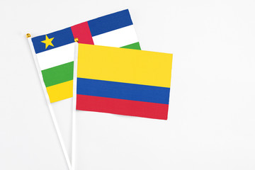 Colombia and Central African Republic stick flags on white background. High quality fabric, miniature national flag. Peaceful global concept.White floor for copy space.
