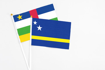 Curacao and Central African Republic stick flags on white background. High quality fabric, miniature national flag. Peaceful global concept.White floor for copy space.