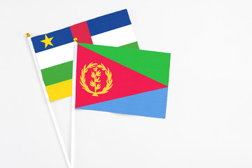 Eritrea and Central African Republic stick flags on white background. High quality fabric, miniature national flag. Peaceful global concept.White floor for copy space.