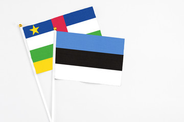 Estonia and Central African Republic stick flags on white background. High quality fabric, miniature national flag. Peaceful global concept.White floor for copy space.
