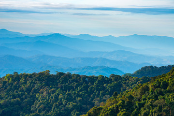 Beautiful Landscape of mountain layer in morning sun ray and green forest.The sunrise shines down the green forest mountain in Thailand.