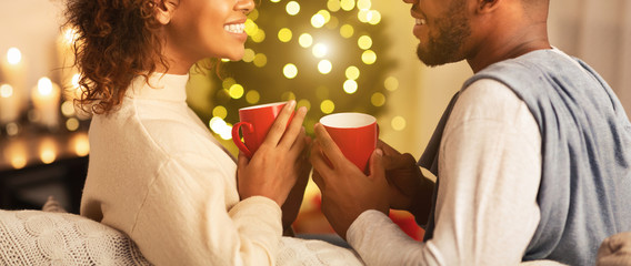 Couple enjoying hot coffee on Christmas eve