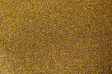 Gold glitter texture.Gilded paper for background