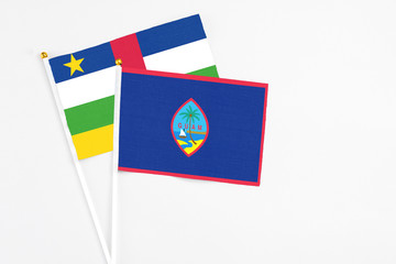 Guam and Central African Republic stick flags on white background. High quality fabric, miniature national flag. Peaceful global concept.White floor for copy space.