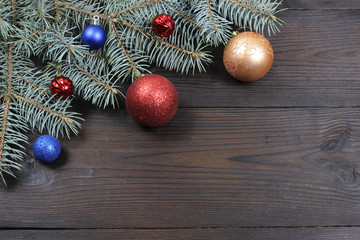 New Year's background. New Year's toys on Christmas tree, wooden background. View from above.