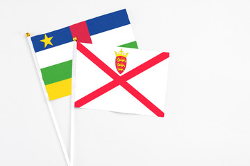Jersey and Central African Republic stick flags on white background. High quality fabric, miniature national flag. Peaceful global concept.White floor for copy space.
