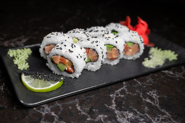 rolls on black background.rice and fish