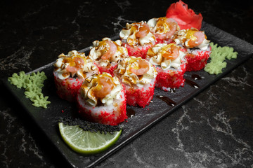 rolls on black background.rice and fish