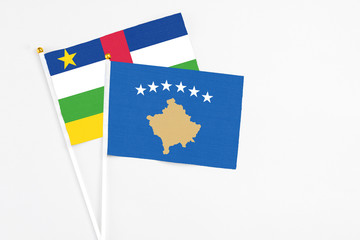 Kosovo and Central African Republic stick flags on white background. High quality fabric, miniature national flag. Peaceful global concept.White floor for copy space.