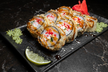 rolls on black background.rice and fish