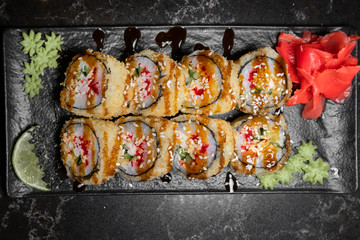 rolls on black background.rice and fish