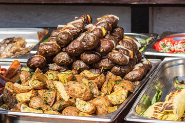 Culinary Buffet with healthy take away meal - grilled vegetables, fish and meat on the street food culinary market, festival, event.  Different types of delicious meat. Outdoor Cuisine. 