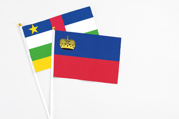 Liechtenstein and Central African Republic stick flags on white background. High quality fabric, miniature national flag. Peaceful global concept.White floor for copy space.