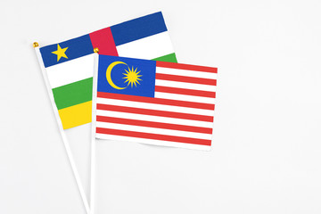 Malaysia and Central African Republic stick flags on white background. High quality fabric, miniature national flag. Peaceful global concept.White floor for copy space.
