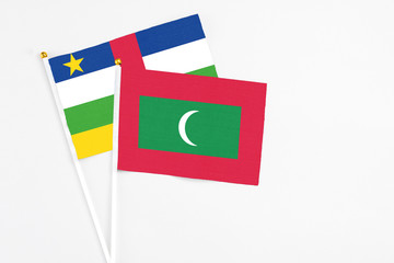 Maldives and Central African Republic stick flags on white background. High quality fabric, miniature national flag. Peaceful global concept.White floor for copy space.