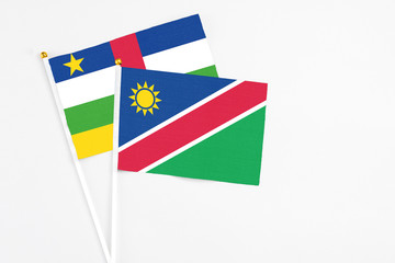 Namibia and Central African Republic stick flags on white background. High quality fabric, miniature national flag. Peaceful global concept.White floor for copy space.