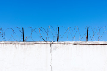 Jail wall. Highly protected prison wall with barbed wire fence