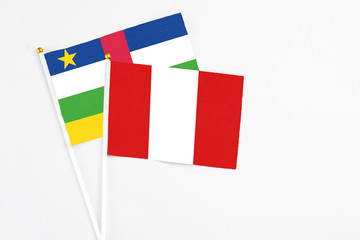 Peru and Central African Republic stick flags on white background. High quality fabric, miniature national flag. Peaceful global concept.White floor for copy space.