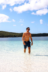 Caucasion guy walking out of Lake McKenzie on Fraser Island, Australia