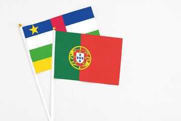 Portugal and Central African Republic stick flags on white background. High quality fabric, miniature national flag. Peaceful global concept.White floor for copy space.