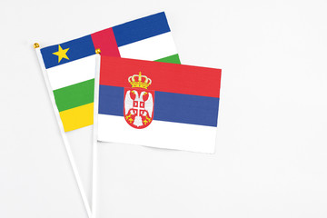 Serbia and Central African Republic stick flags on white background. High quality fabric, miniature national flag. Peaceful global concept.White floor for copy space.