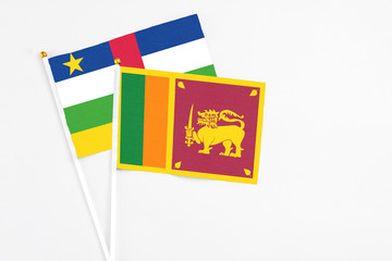 Sri Lanka and Central African Republic stick flags on white background. High quality fabric, miniature national flag. Peaceful global concept.White floor for copy space.