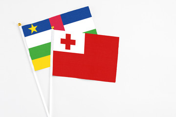 Tonga and Central African Republic stick flags on white background. High quality fabric, miniature national flag. Peaceful global concept.White floor for copy space.