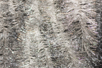 Festive multicolored shiny beautiful Christmas plastic garland sparkling for the New Year, Christmas-tree tinsel, festive decorated.