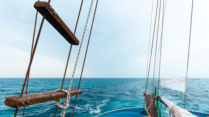 The stern of a ship with the trail in the sea in the background
