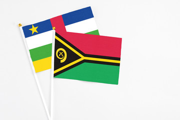 Vanuatu and Central African Republic stick flags on white background. High quality fabric, miniature national flag. Peaceful global concept.White floor for copy space.